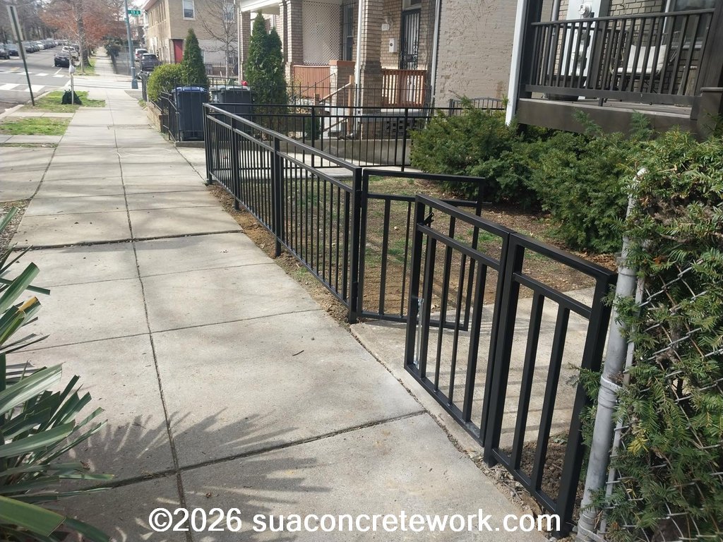 Custom metal railing welding project along a sidewalk